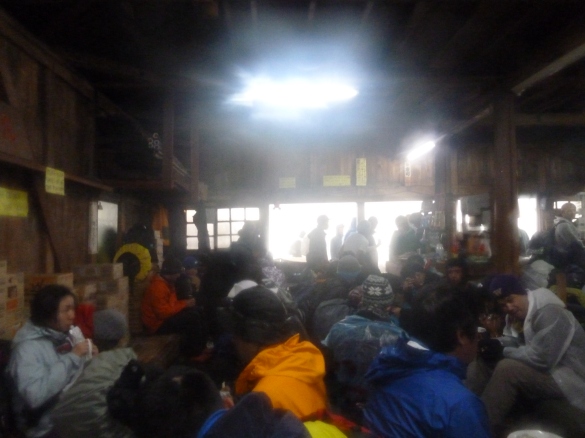 The handful of climbers who made it huddle together for warmth on the summit's hut.